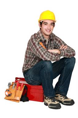 portrait of young craftsman sitting on toolcase